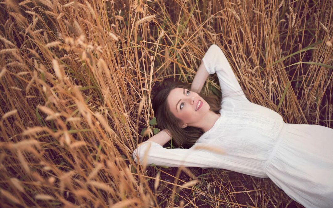 Find acceptance: Woman lying back in long grass